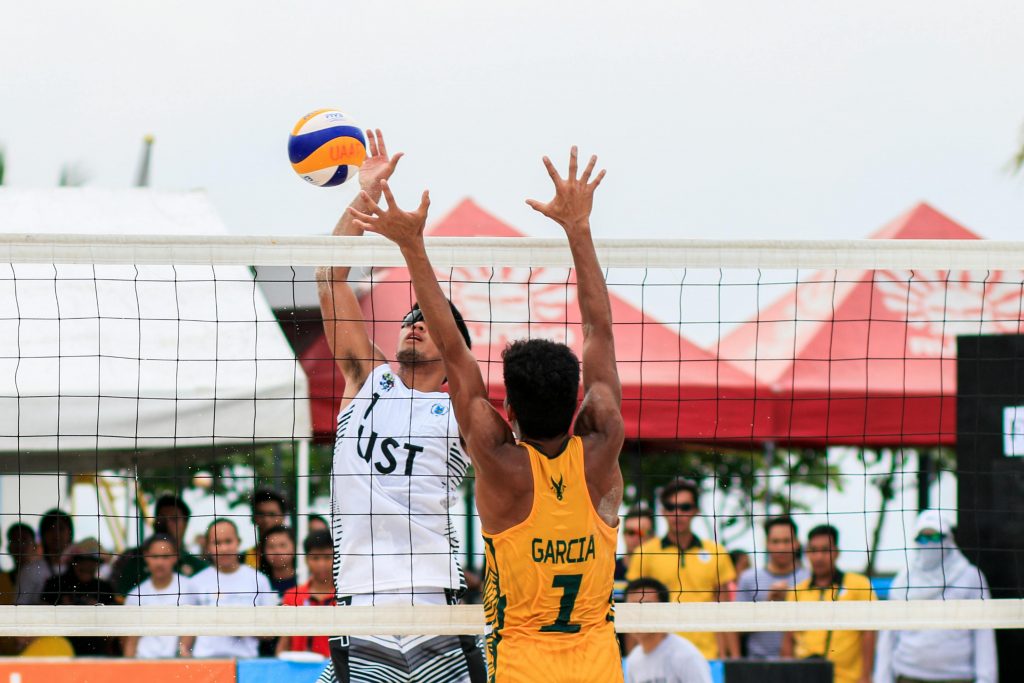 Beach volleyball action shot of two players competing at a tournament in Pasay, Philippines.